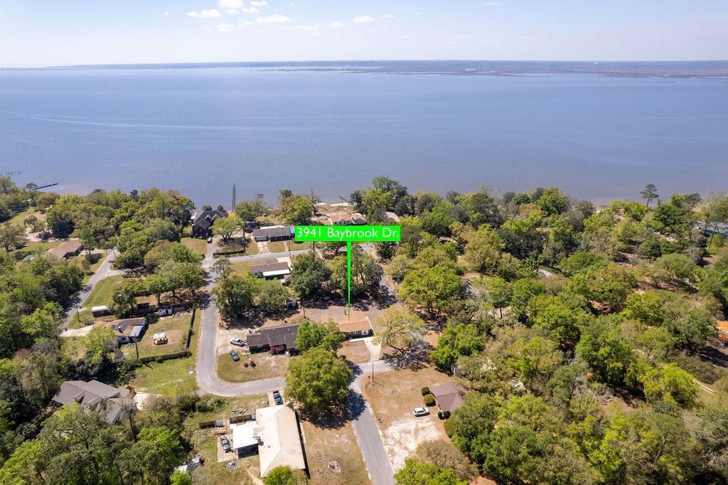 3941 Baybrook Drive Pace, FL 32571 - Photo 24 of 28 a view of a garden with a building in the background