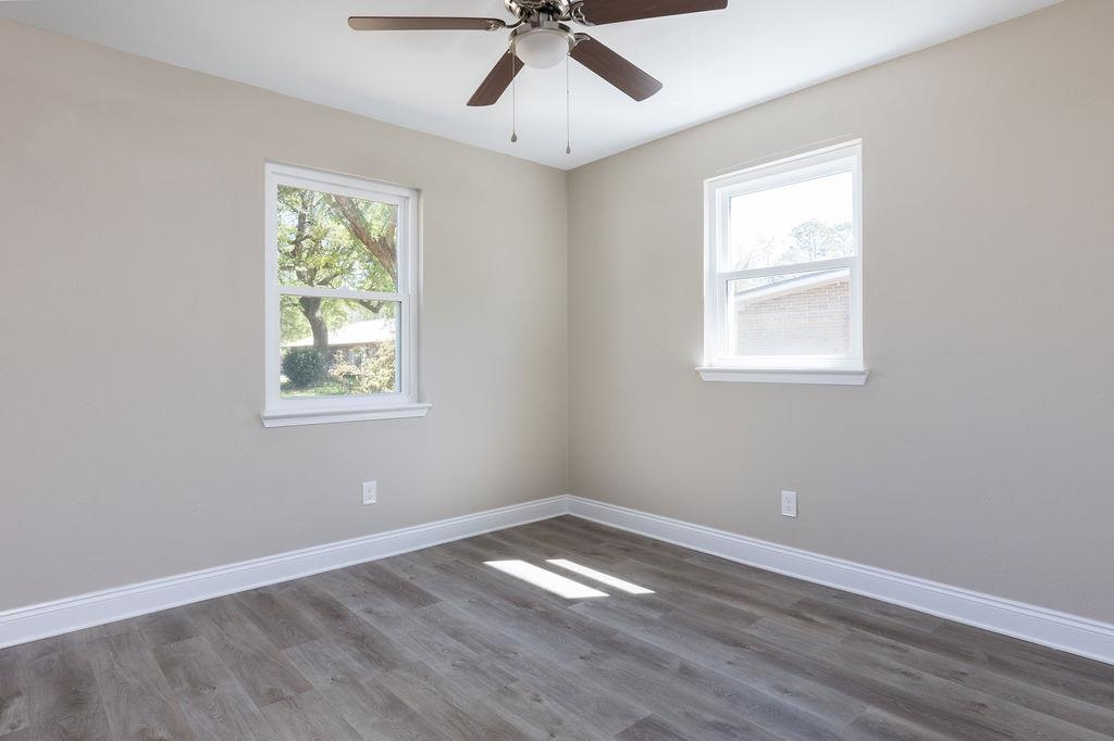 3941 Baybrook Drive Pace, FL 32571 - Photo 8 of 28 an empty room with a window and a fan