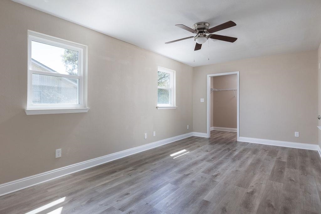 3941 Baybrook Drive Pace, FL 32571 - Photo 9 of 28 an empty room with wooden floor and windows