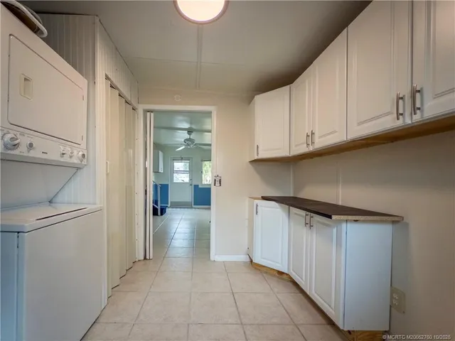 a kitchen with a refrigerator and cabinets