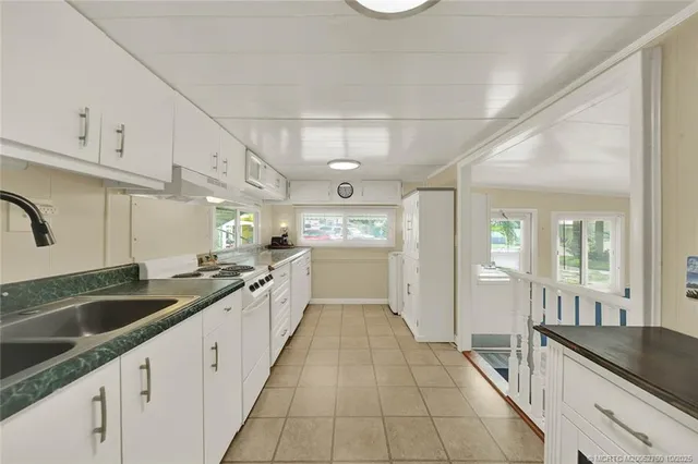 a large kitchen with a sink and cabinets