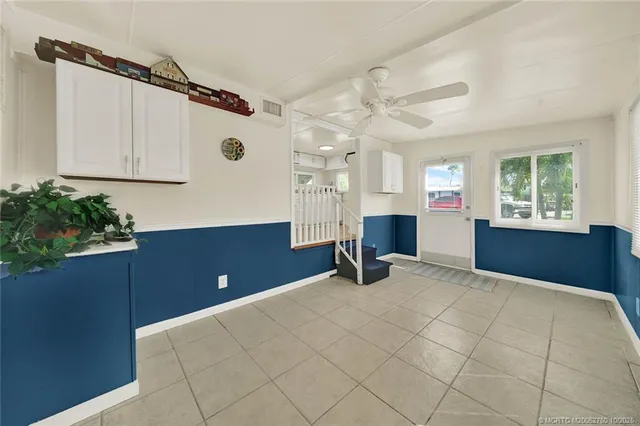 a view of a bedroom with window and cabinet