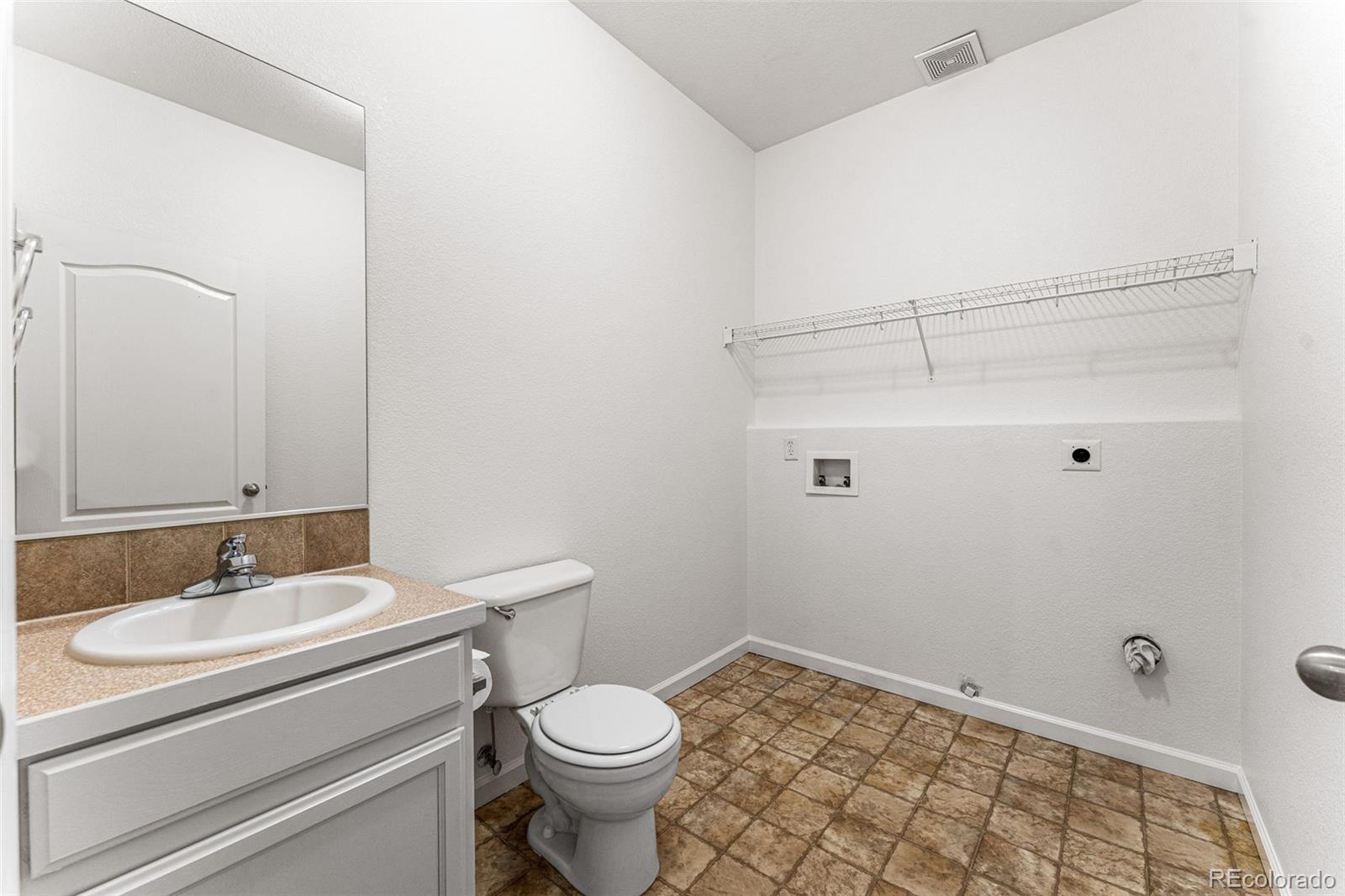 400 Sorrel Drive Windsor, CO 80550 - Photo 14 of 37 a bathroom with a sink toilet and vanity