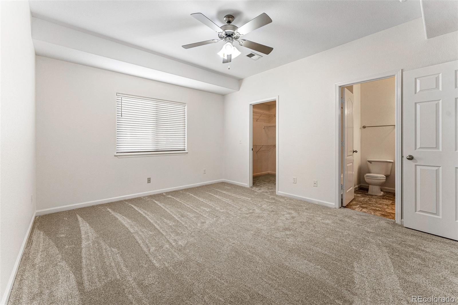 400 Sorrel Drive Windsor, CO 80550 - Photo 16 of 37 a view of a bedroom with a ceiling fan and a window