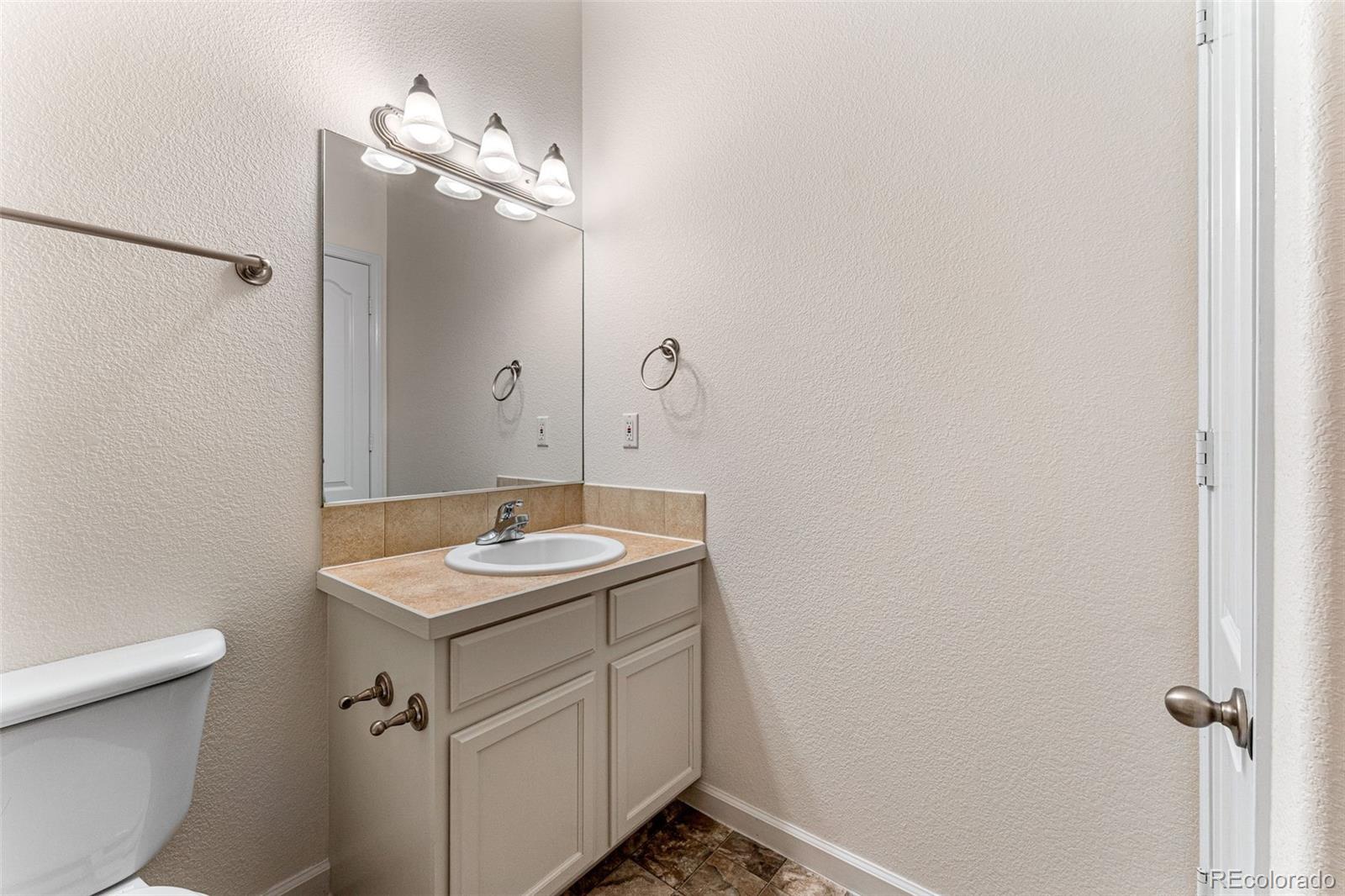 400 Sorrel Drive Windsor, CO 80550 - Photo 19 of 37 a bathroom with a sink and mirror with toilet