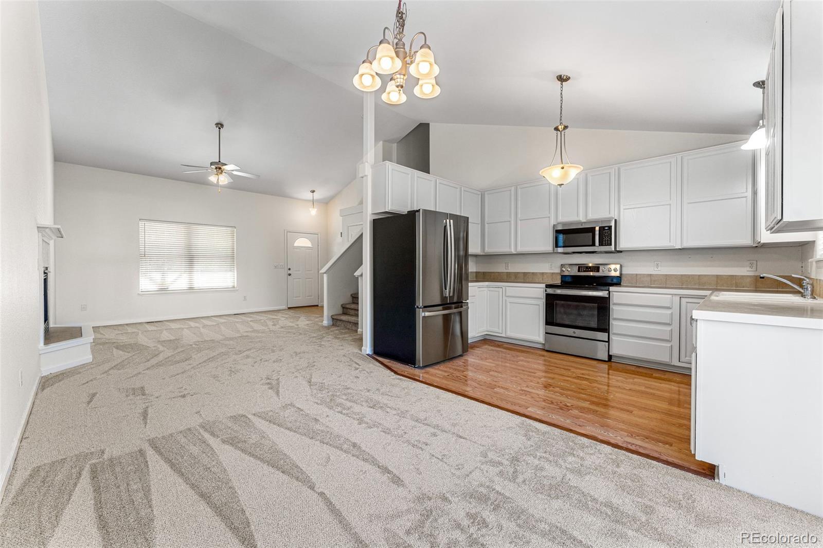 400 Sorrel Drive Windsor, CO 80550 - Photo 6 of 37 a large kitchen with cabinets and stainless steel appliances