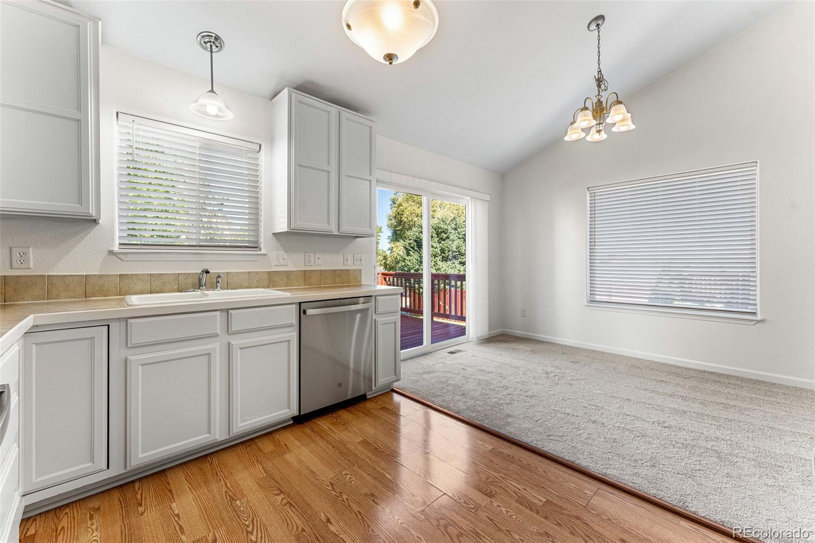 400 Sorrel Drive Windsor, CO 80550 - Photo 8 of 37 a kitchen with a sink window and cabinets