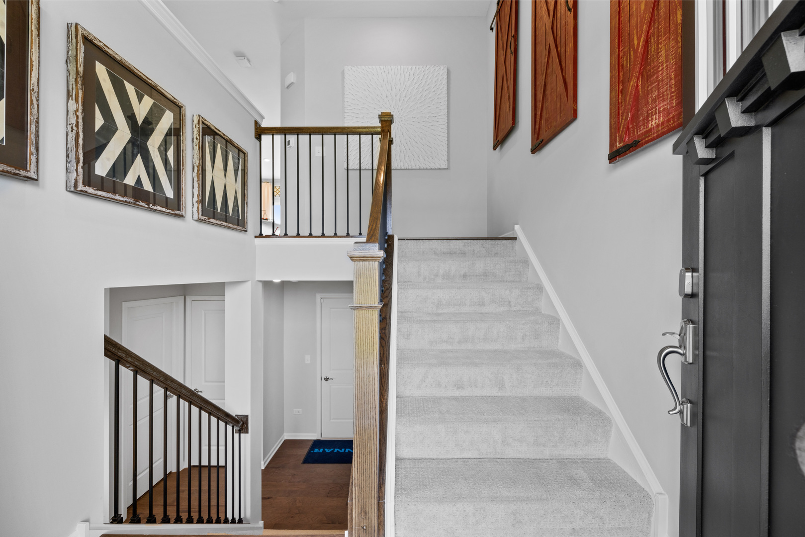 559 Wolverine Drive Aurora, IL 60502 - Photo 4 of 33 a view of staircase with lots of frames on wall and a window