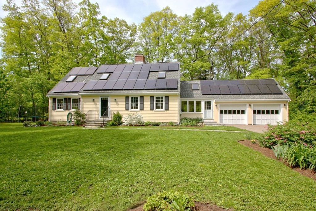 25 3 Ponds Road Wayland, MA 01778 - Photo 1 of 29 a front view of a house with a garden