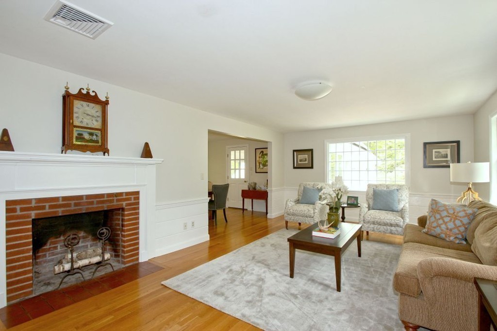25 3 Ponds Road Wayland, MA 01778 - Photo 2 of 29 a living room with furniture and a fireplace