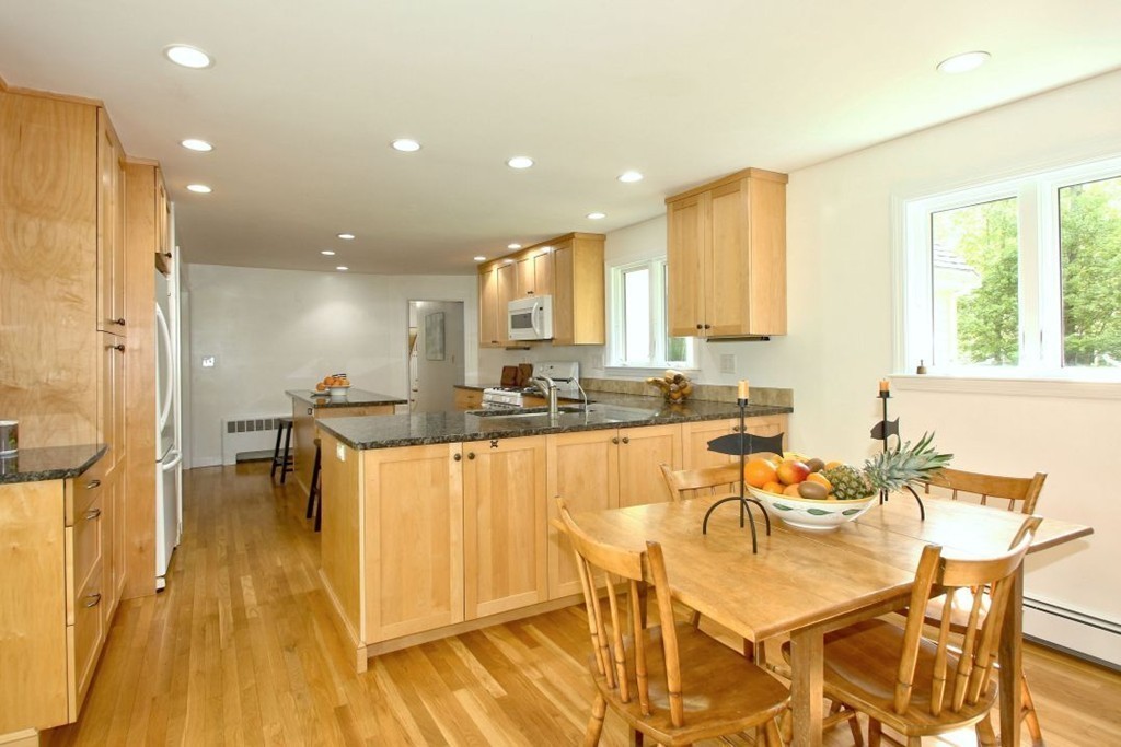 25 3 Ponds Road Wayland, MA 01778 - Photo 9 of 29 a view of a dining room with furniture and a wooden floor