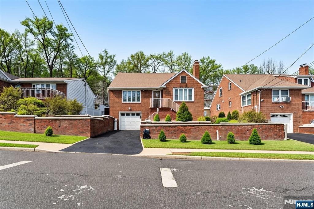 a front view of a house with a yard and a garage