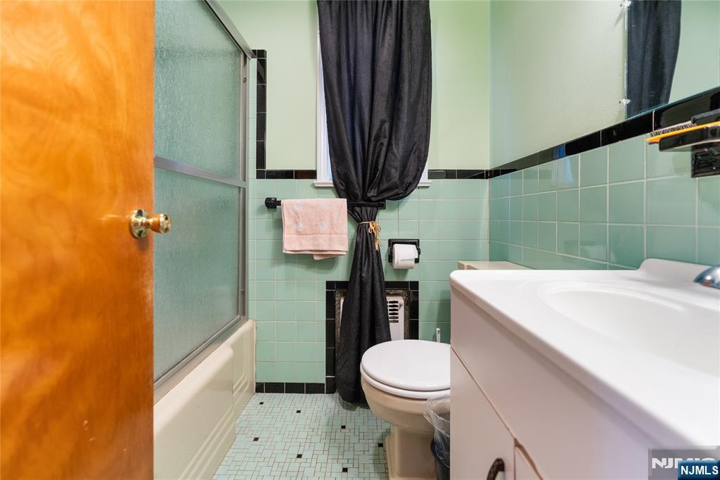 722 Oak Street Ridgefield, NJ 07657 - Photo 11 of 17 a bathroom with a sink a toilet and shower