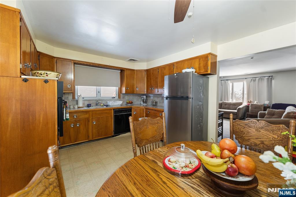 722 Oak Street Ridgefield, NJ 07657 - Photo 5 of 17 a kitchen with refrigerator and chairs
