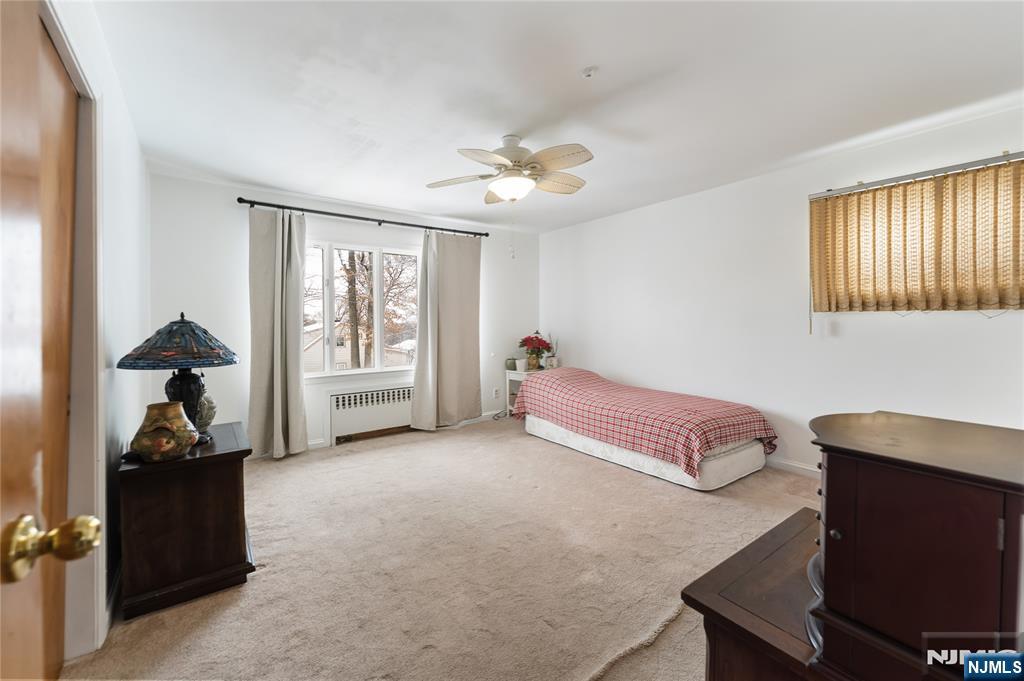 722 Oak Street Ridgefield, NJ 07657 - Photo 6 of 17 a spacious bedroom with a bed and a window