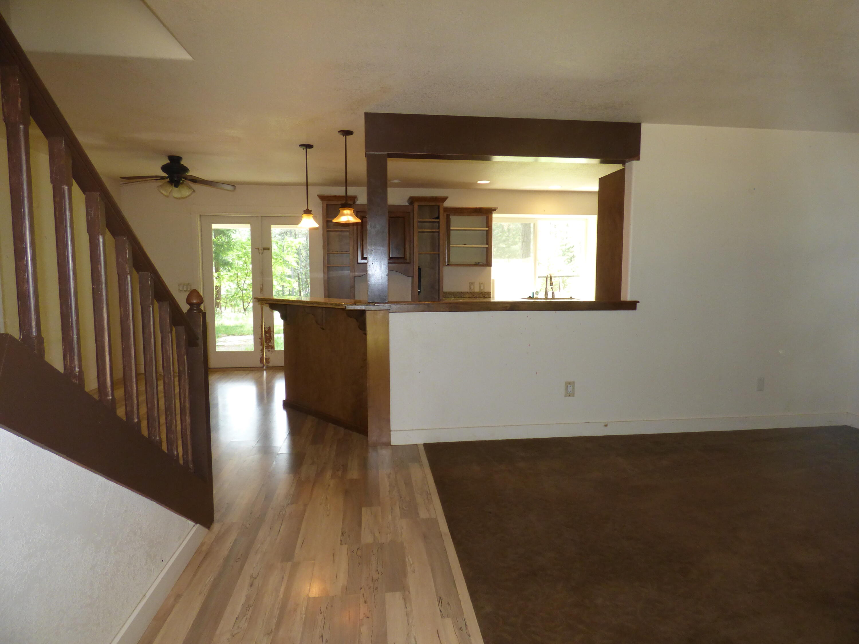 7414 Redthorne Road Rogue River, OR 97537 - Photo 10 of 32 a view of a room with wooden floor and staircase
