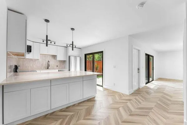 a bedroom with a large bed and windows