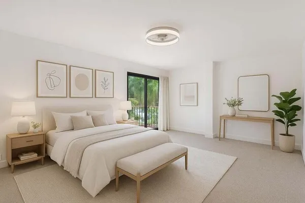 a bedroom with bed and a potted plant