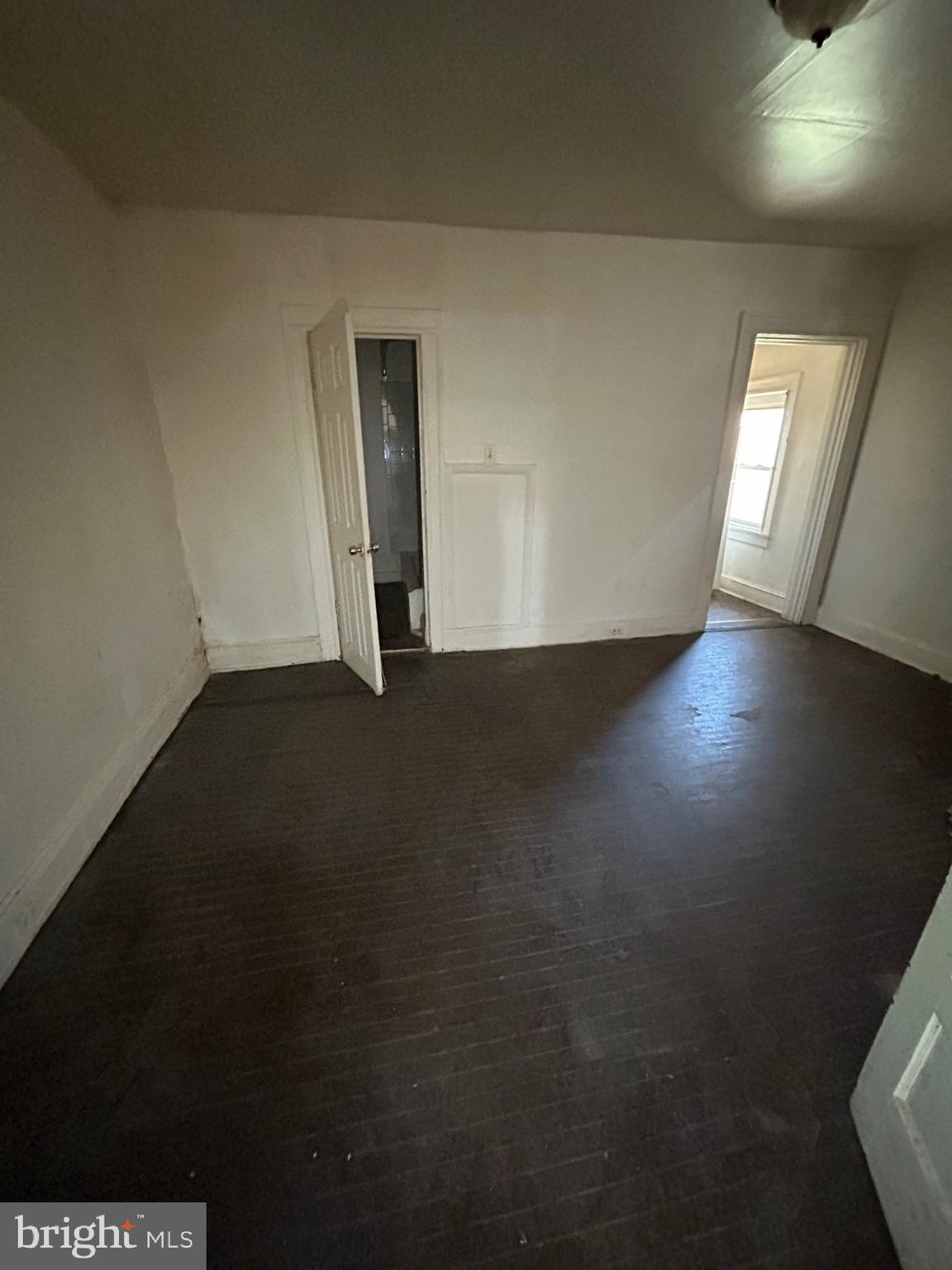 3206 Hayward Avenue Baltimore, MD 21215 - Photo 4 of 12 an empty room with wooden floor and windows