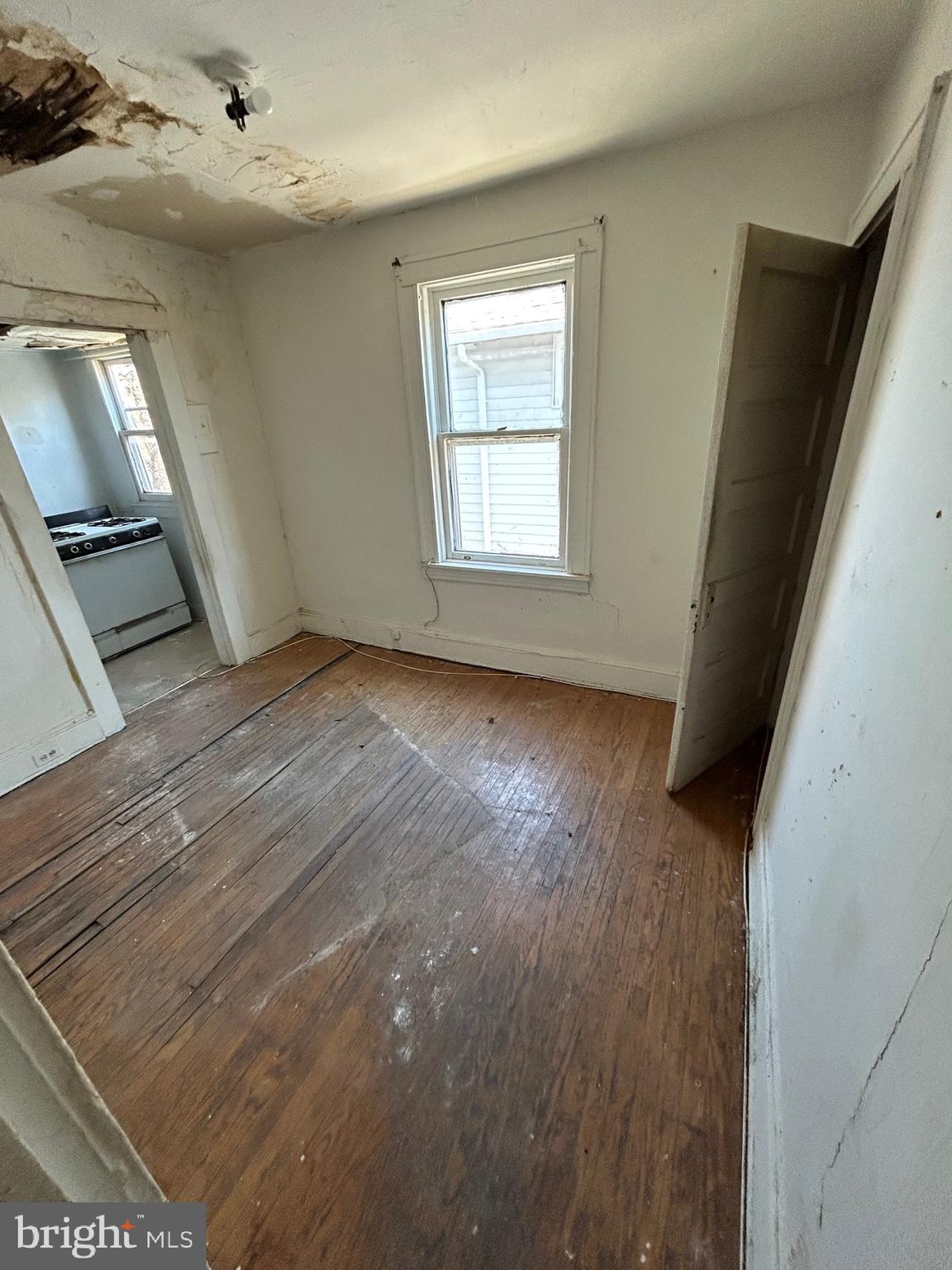 3206 Hayward Avenue Baltimore, MD 21215 - Photo 9 of 12 wooden floor in an empty room with a window