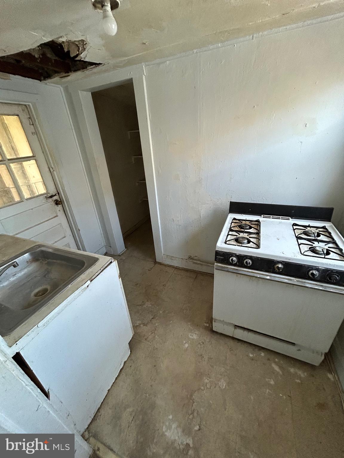 3206 Hayward Avenue Baltimore, MD 21215 - Photo 10 of 12 a view of kitchen with sink and washing machine