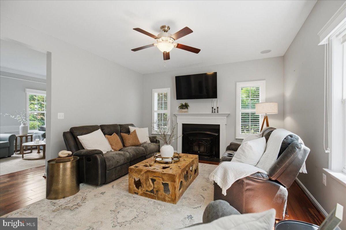 2424 Springbrook Court Huntingtown, MD 20639 - Photo 24 of 103 a living room with furniture a fireplace and a flat screen tv