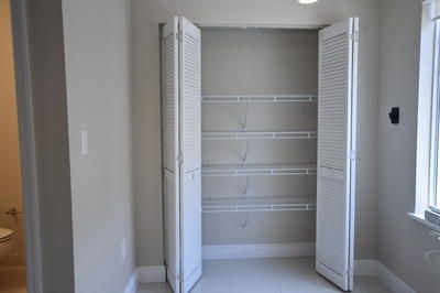 a view of walk in closet with empty racks