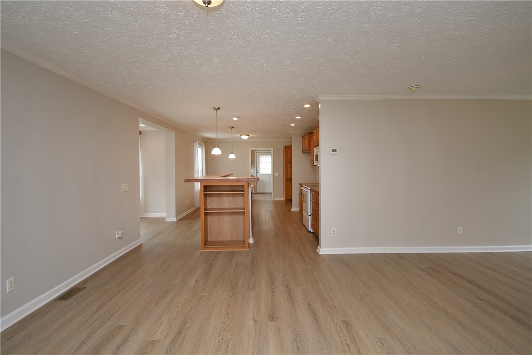579 Daventon Road Honea Path, SC 29654 - Photo 41 of 44 An open floorplan with hardwood floors connects the living space and kitchen.