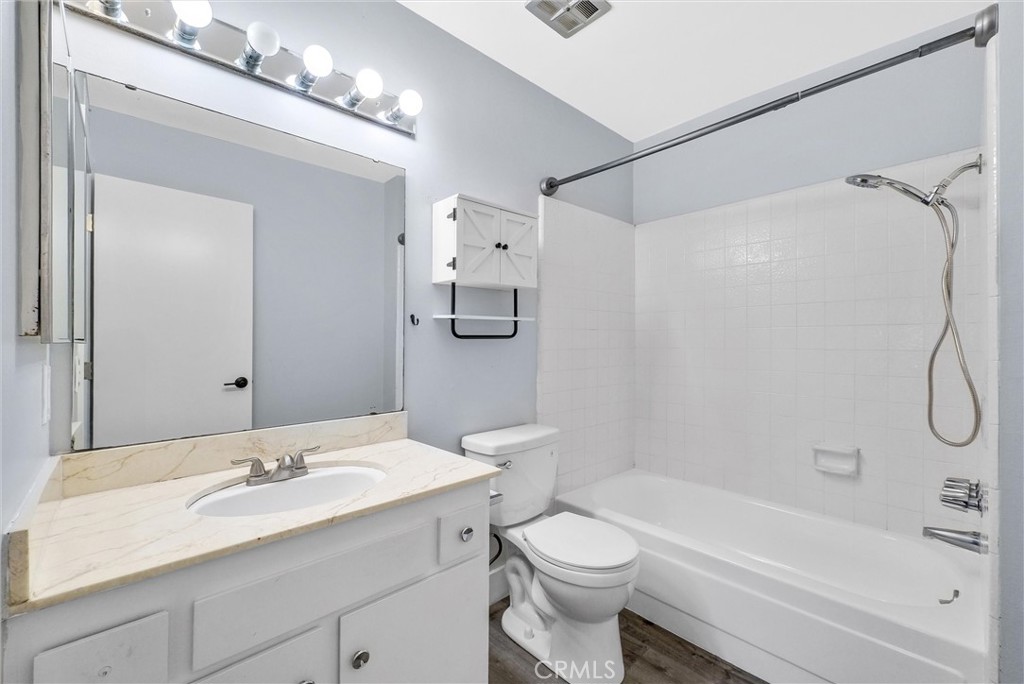13966 Hammon Place Westminster, CA 92683 - Photo 24 of 45 a bathroom with a granite countertop sink a toilet and shower