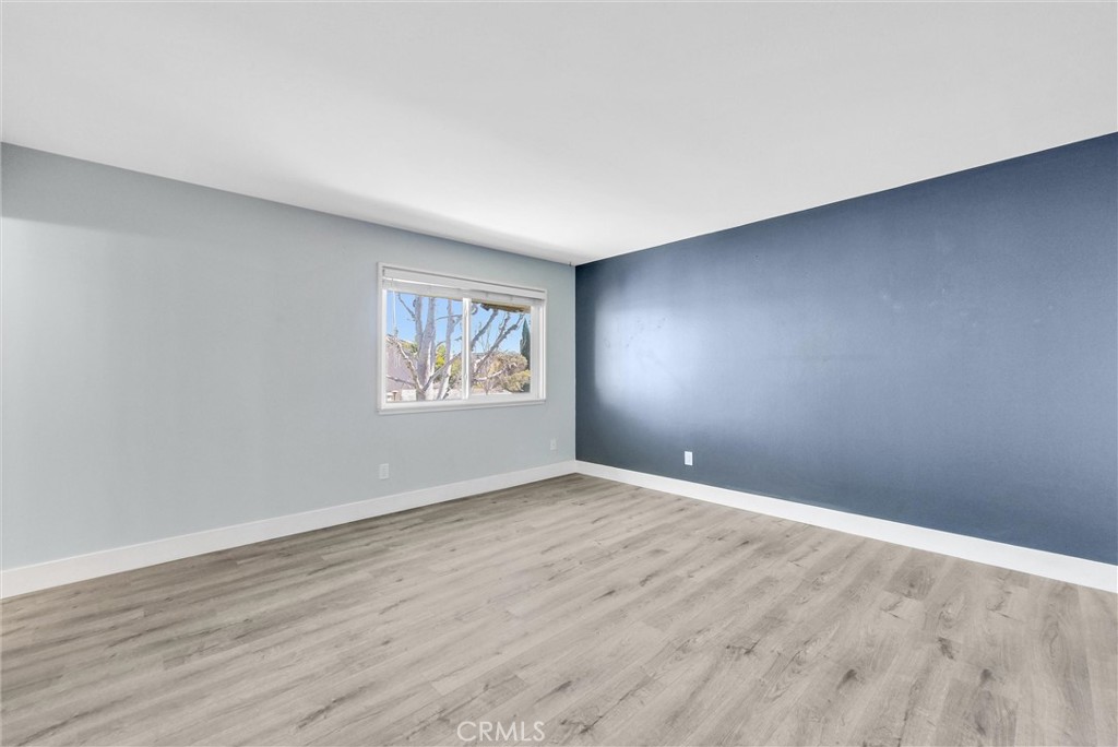 13966 Hammon Place Westminster, CA 92683 - Photo 26 of 45 an empty room with wooden floor and windows
