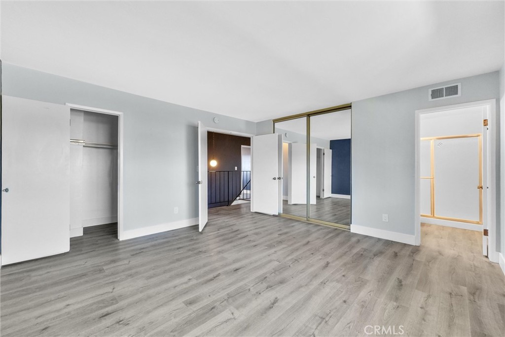 13966 Hammon Place Westminster, CA 92683 - Photo 28 of 45 an empty room with wooden floor & windows and bathroom