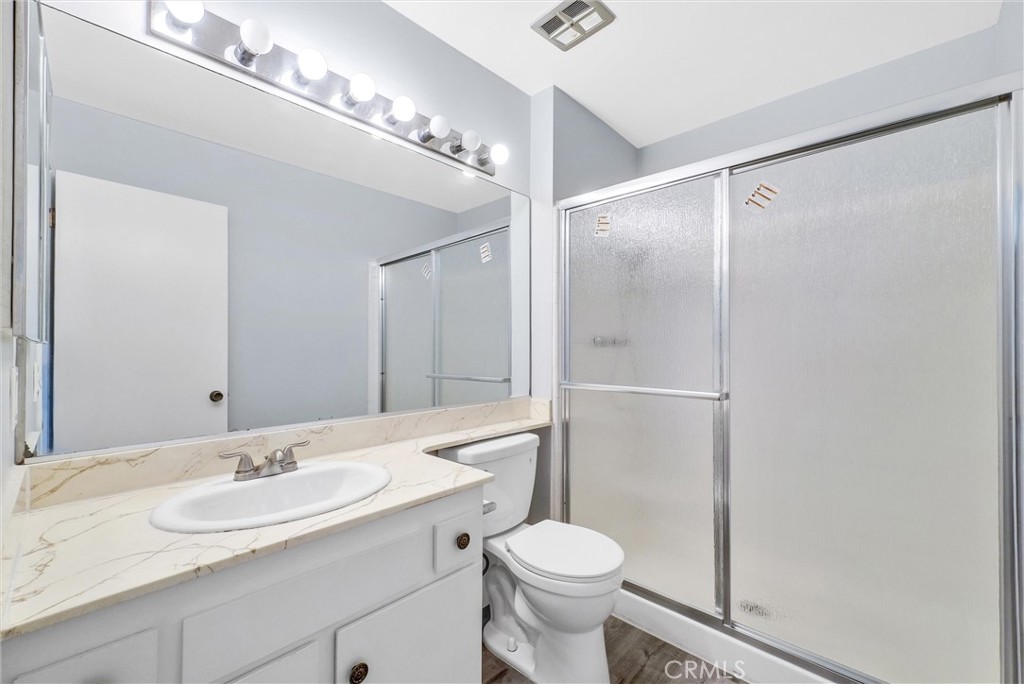 13966 Hammon Place Westminster, CA 92683 - Photo 29 of 45 a bathroom with a sink a toilet a mirror and shower