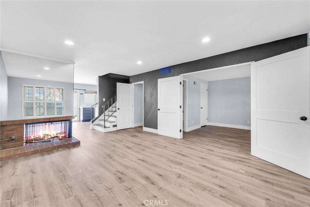 13966 Hammon Place Westminster, CA 92683 - Photo 6 of 45 a view of an empty room with wooden floor and a window