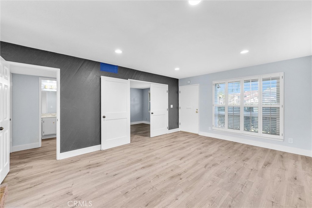 13966 Hammon Place Westminster, CA 92683 - Photo 7 of 45 a view of empty room with wooden floor and windows