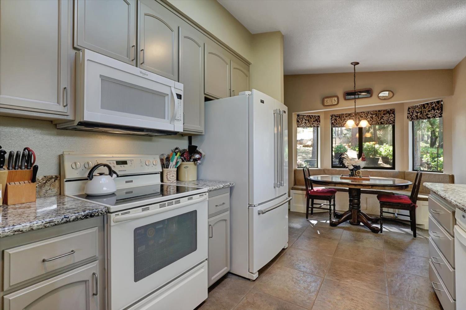 17682 Alexandra Way Grass Valley, CA 95949 - Photo 15 of 55 a kitchen with stainless steel appliances granite countertop a refrigerator stove and sink