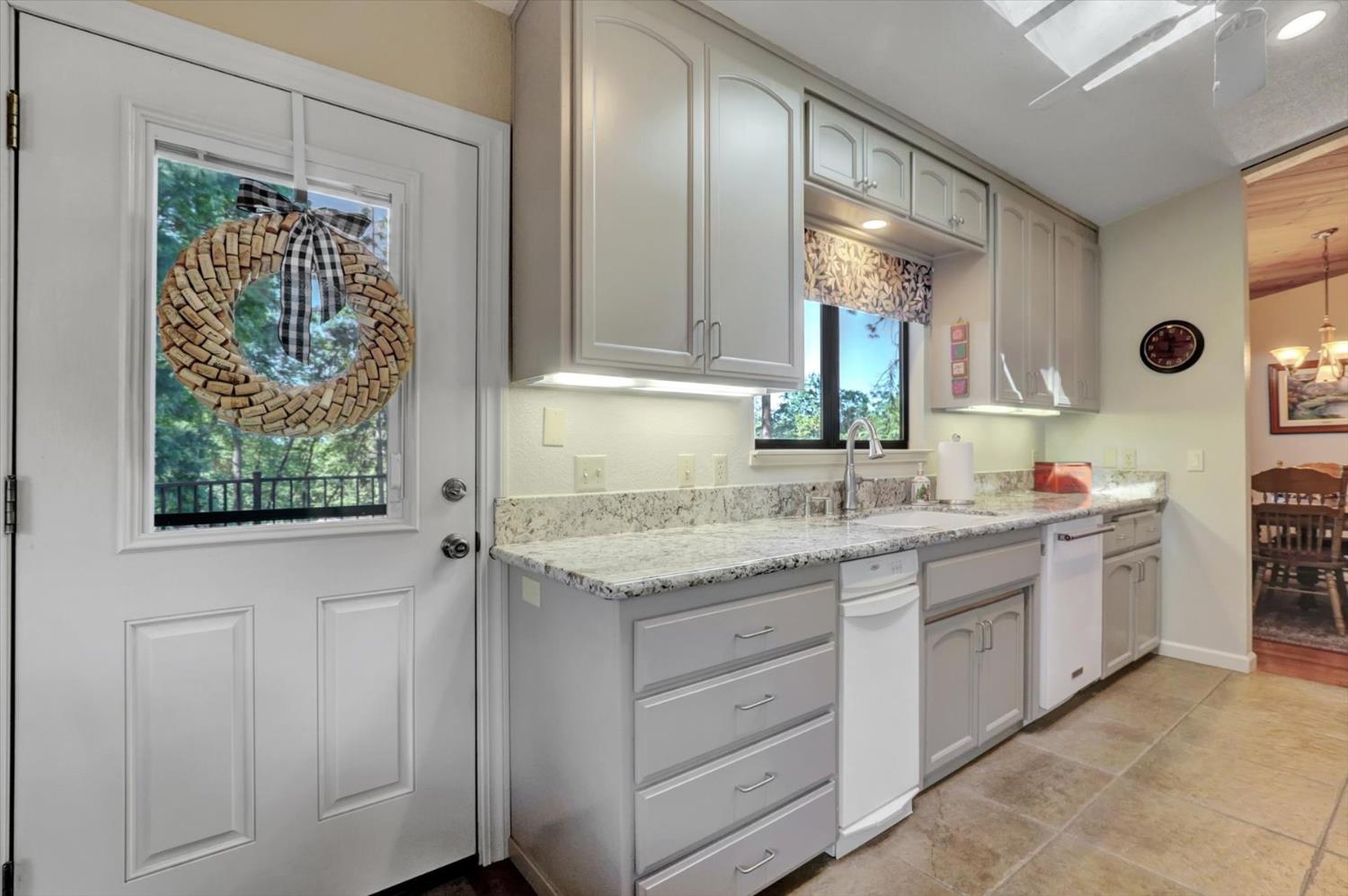 17682 Alexandra Way Grass Valley, CA 95949 - Photo 16 of 55 a bathroom with a granite countertop sink and a mirror