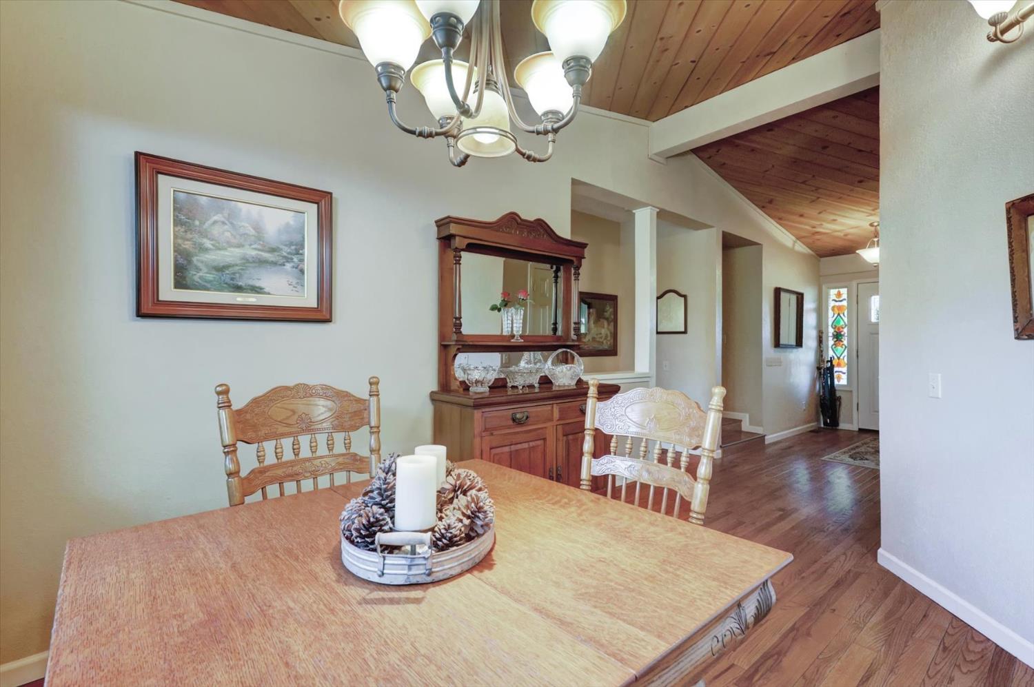 17682 Alexandra Way Grass Valley, CA 95949 - Photo 20 of 55 a dining room with wooden floor and chandelier