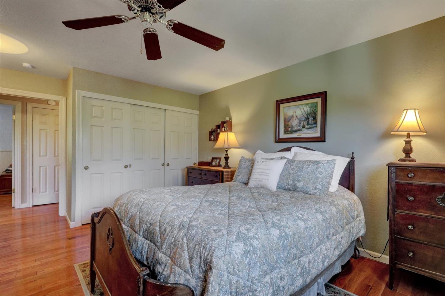 17682 Alexandra Way Grass Valley, CA 95949 - Photo 22 of 55 a bedroom with a bed and wooden floor