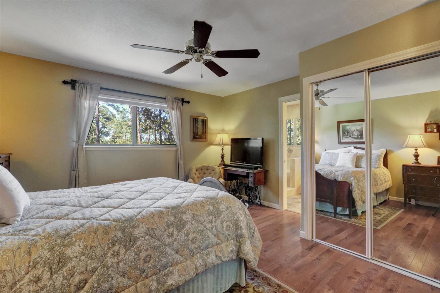 17682 Alexandra Way Grass Valley, CA 95949 - Photo 23 of 55 a bedroom with a bed and a flat screen tv