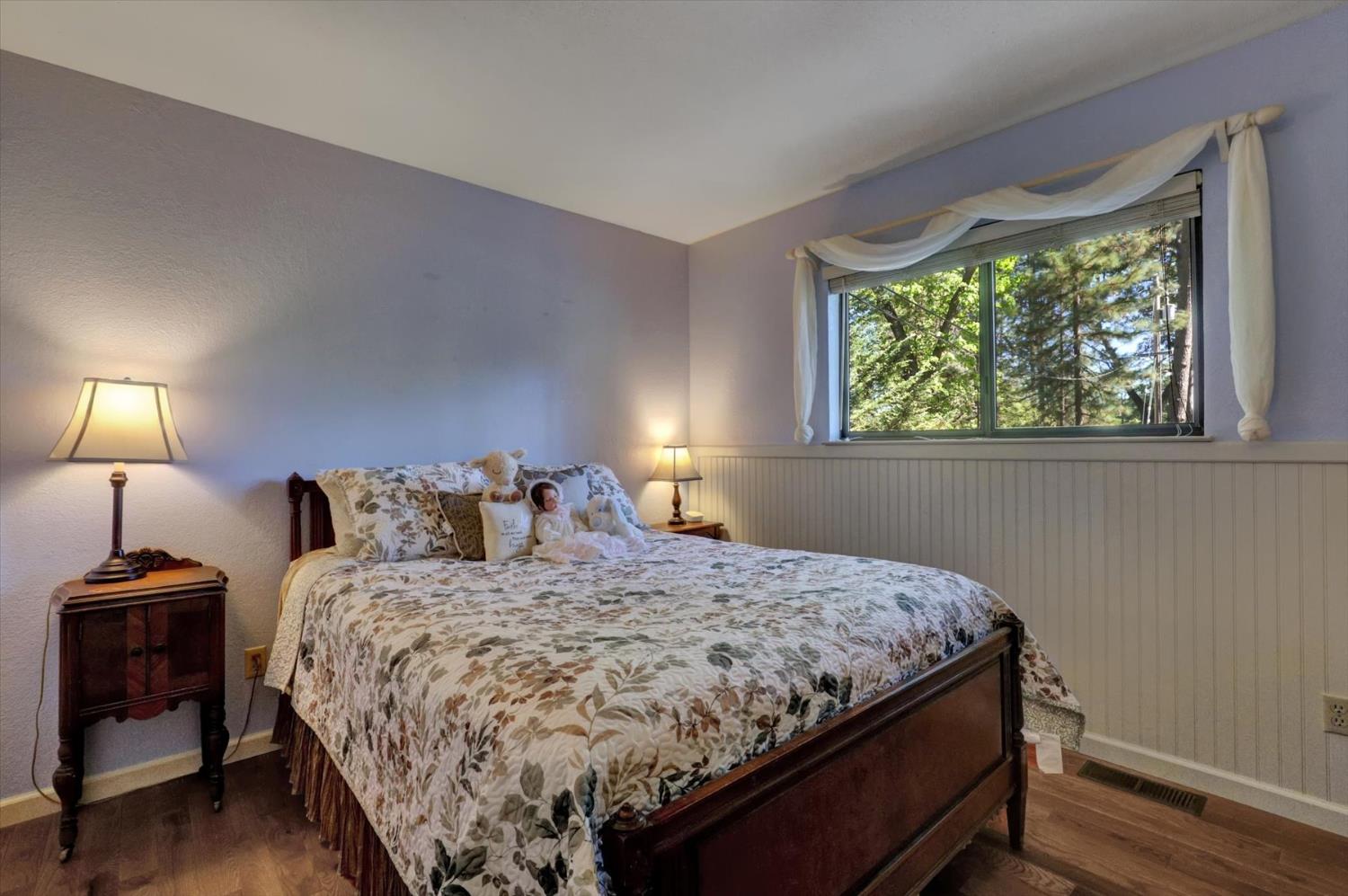 17682 Alexandra Way Grass Valley, CA 95949 - Photo 26 of 55 a bedroom with a bed and a lamp