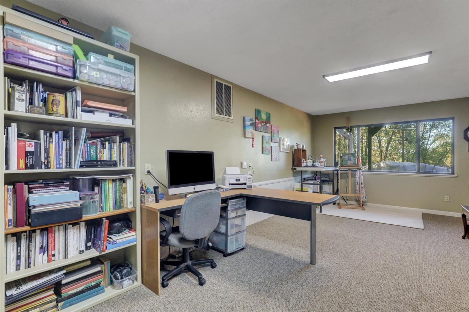 17682 Alexandra Way Grass Valley, CA 95949 - Photo 33 of 55 a view of a workspace with furniture and a bookshelf