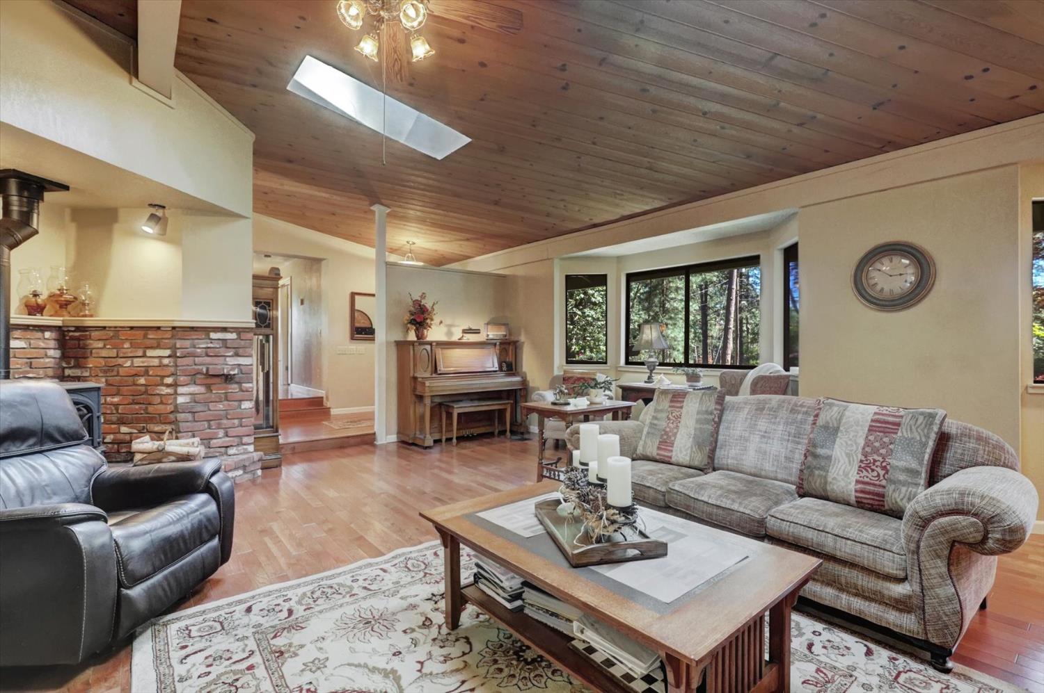 17682 Alexandra Way Grass Valley, CA 95949 - Photo 9 of 55 a living room with furniture a fireplace and a table