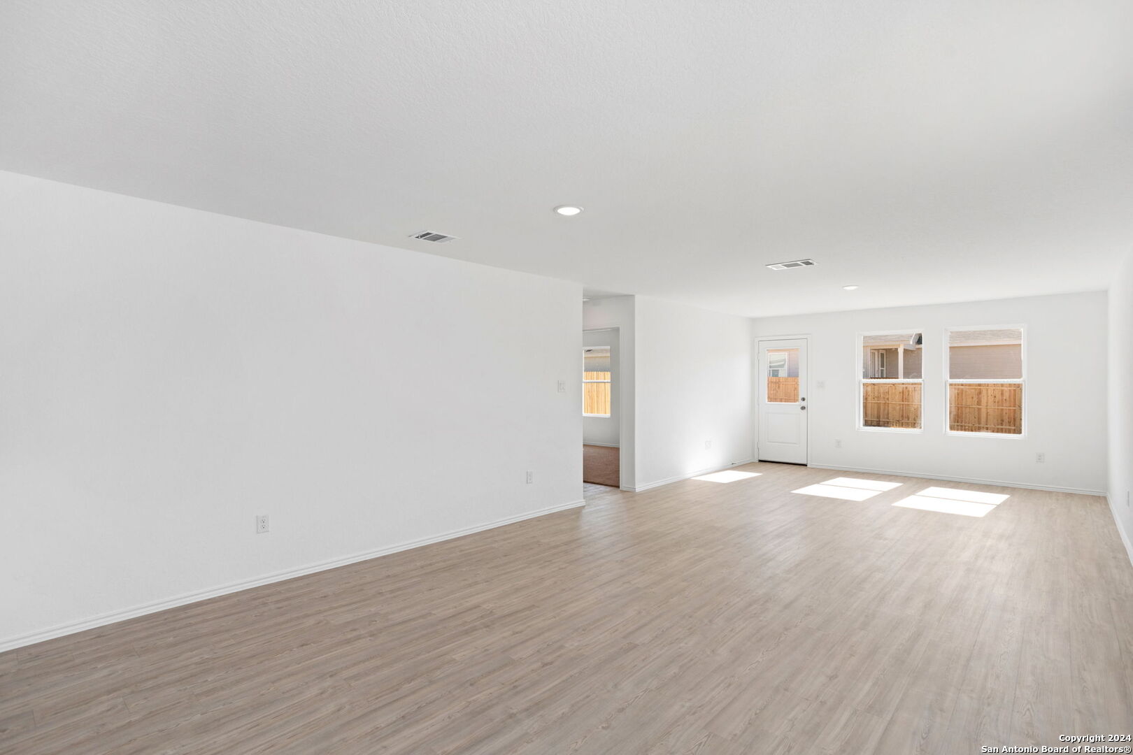 942 Landon Ridge San Antonio, TX 78253 - Photo 11 of 38 a view of an empty room with wooden floor and a window