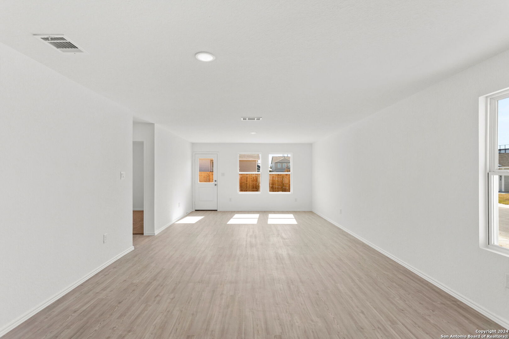 942 Landon Ridge San Antonio, TX 78253 - Photo 12 of 38 an empty room with wooden floor and windows