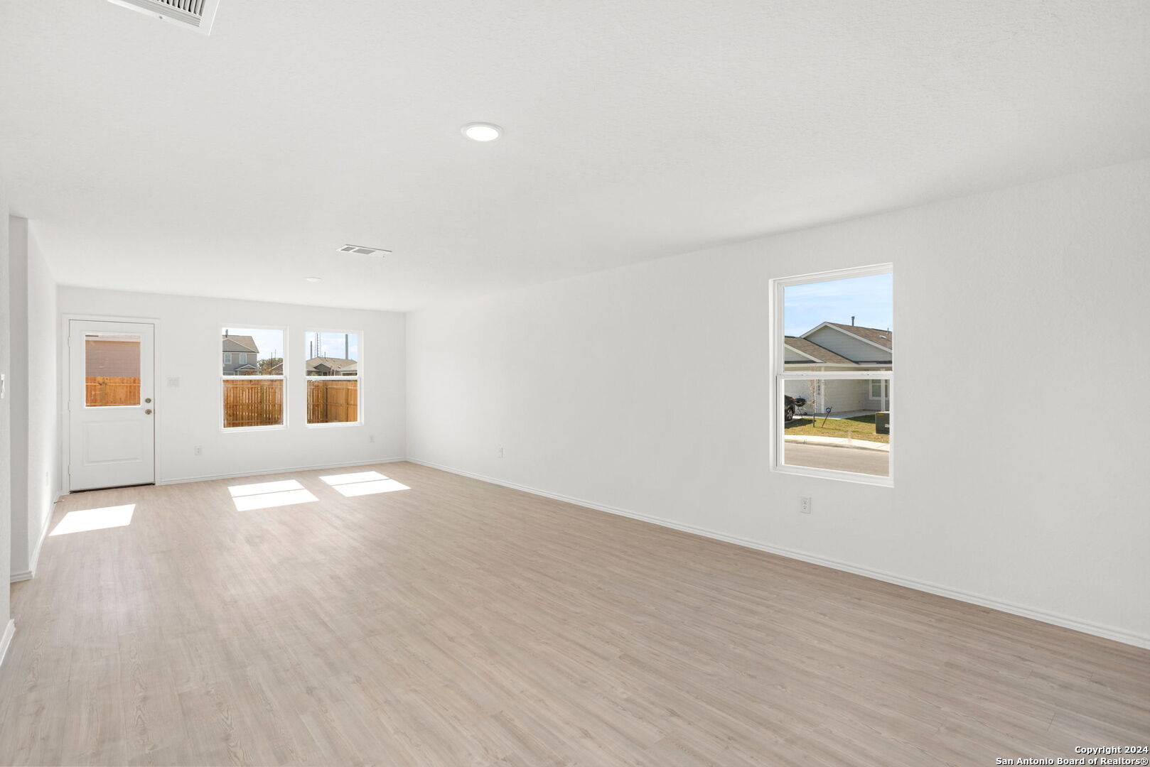 942 Landon Ridge San Antonio, TX 78253 - Photo 13 of 38 an empty room with wooden floor and windows