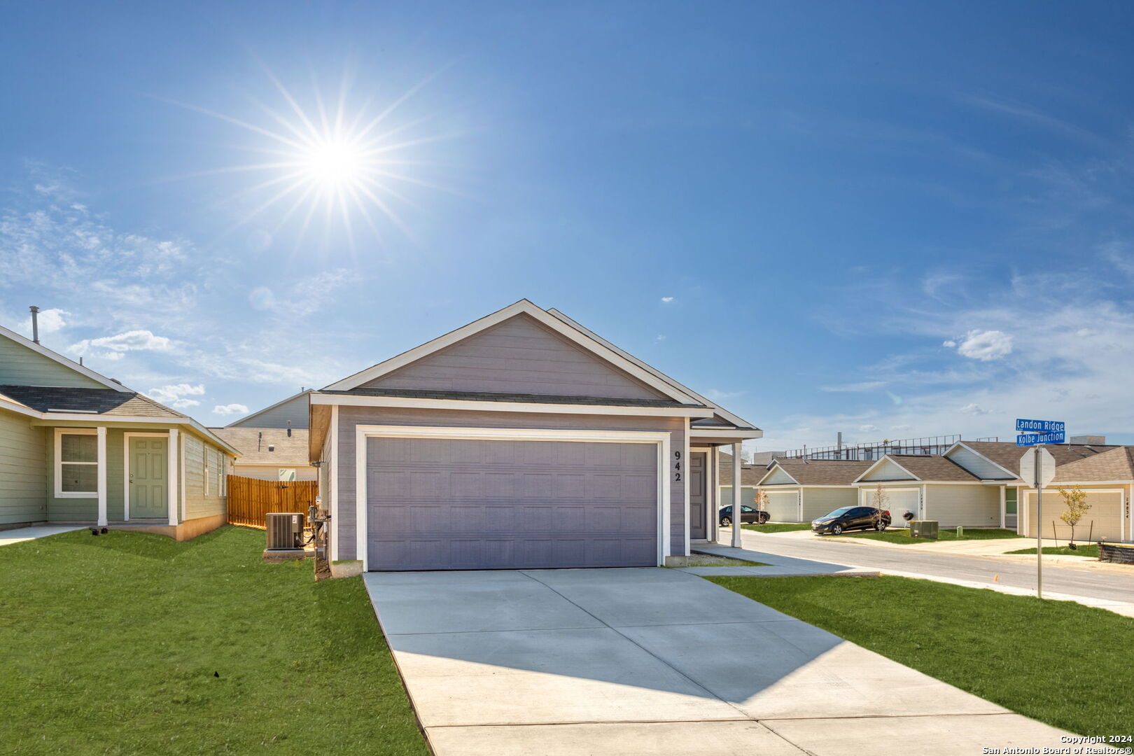 942 Landon Ridge San Antonio, TX 78253 - Photo 2 of 38 a front view of a house with a yard and garage