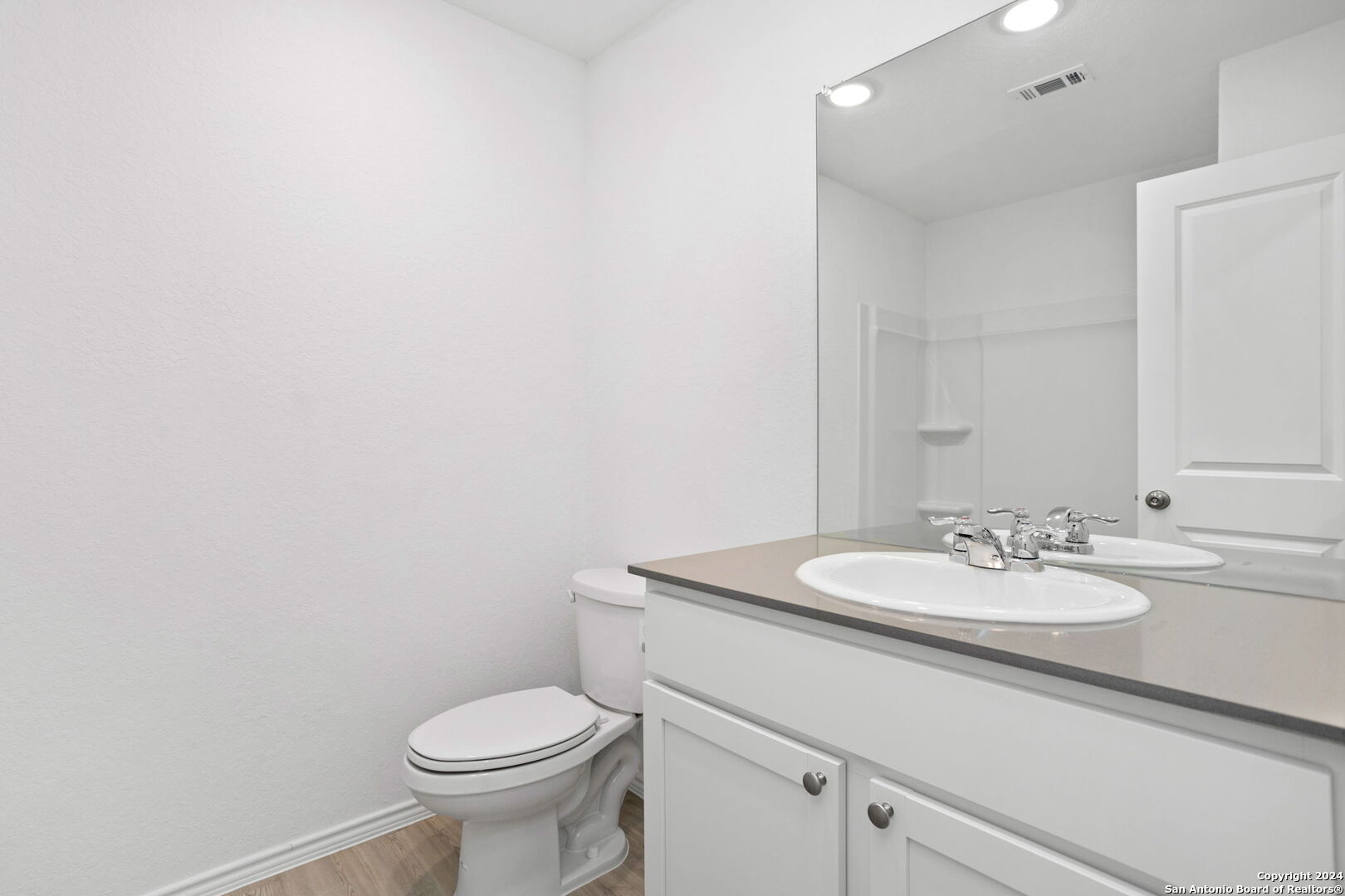 942 Landon Ridge San Antonio, TX 78253 - Photo 24 of 38 a bathroom with a toilet sink and mirror
