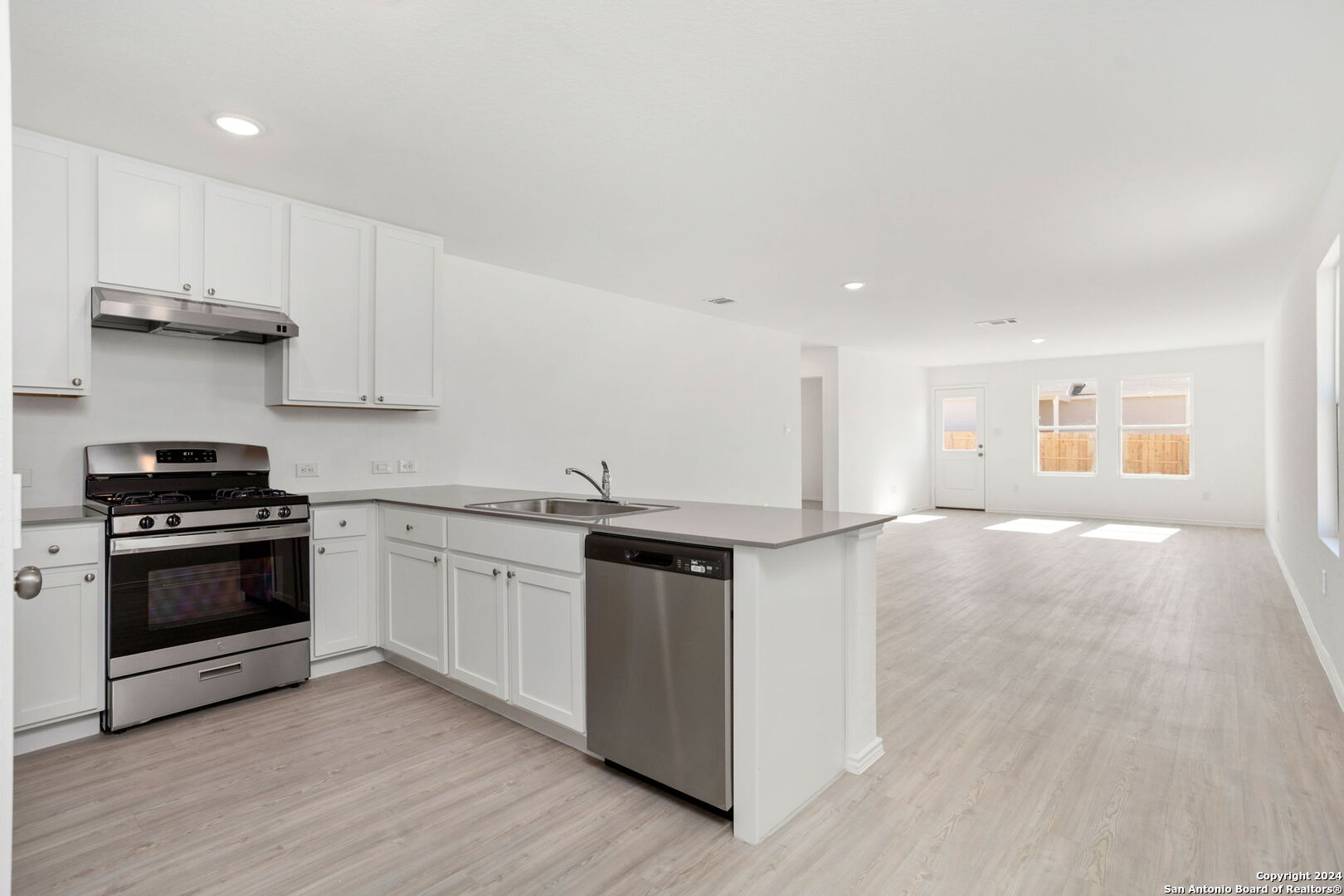 942 Landon Ridge San Antonio, TX 78253 - Photo 6 of 38 a kitchen with stainless steel appliances granite countertop a stove and a sink