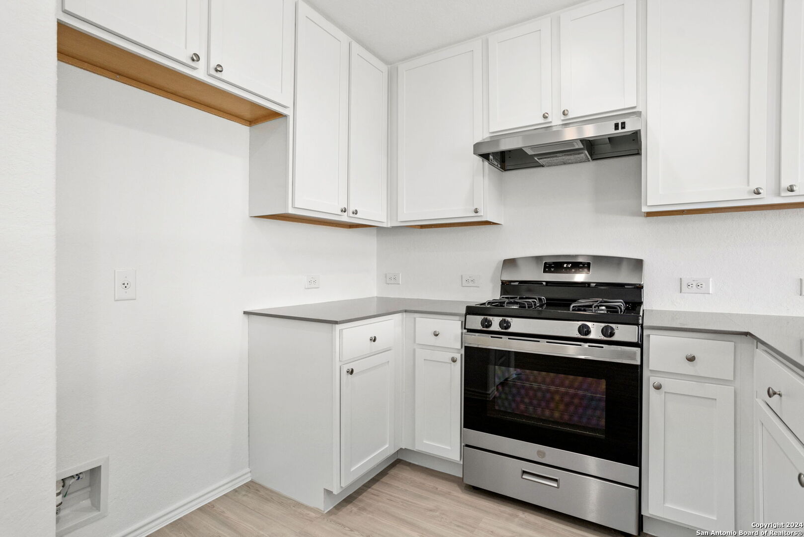942 Landon Ridge San Antonio, TX 78253 - Photo 8 of 38 a kitchen with white cabinets and a stove top oven