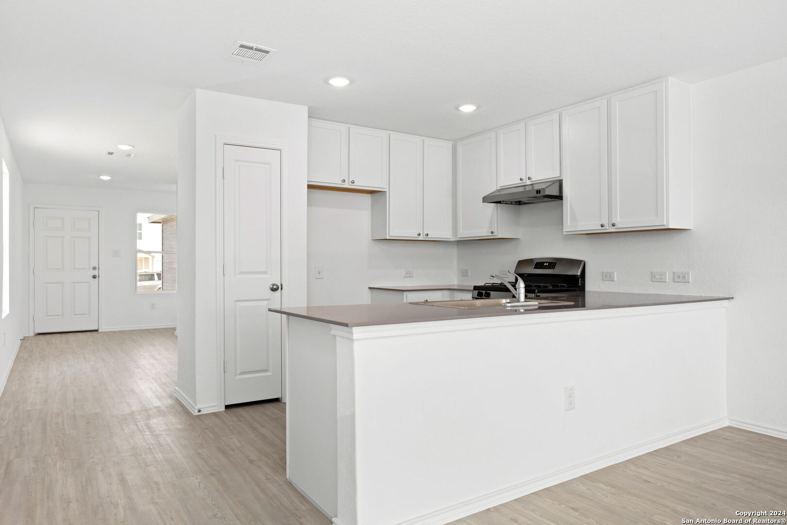 942 Landon Ridge San Antonio, TX 78253 - Photo 10 of 38 a kitchen with stainless steel appliances granite countertop a refrigerator sink and white cabinets